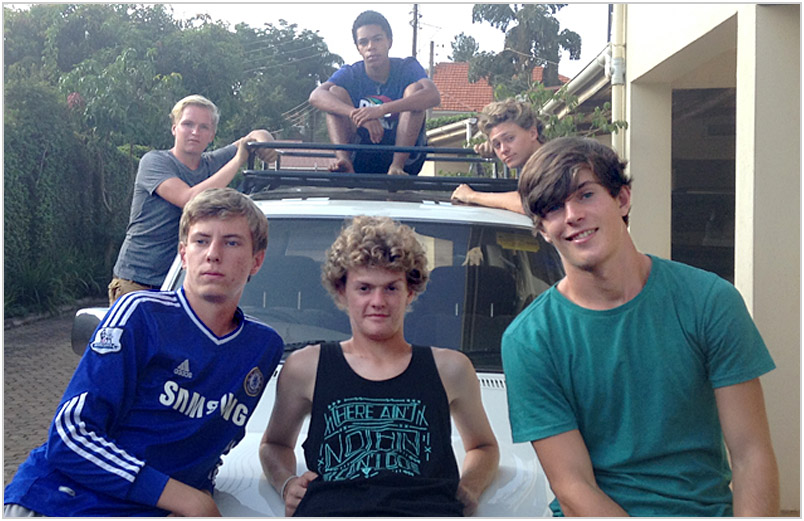 Austin with friends on the hood of a car