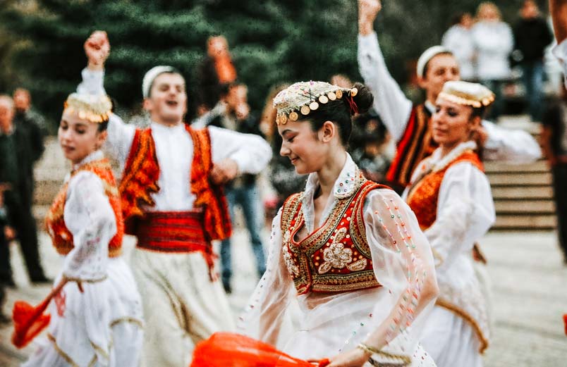 Albanian performers dancing in traditional garb 