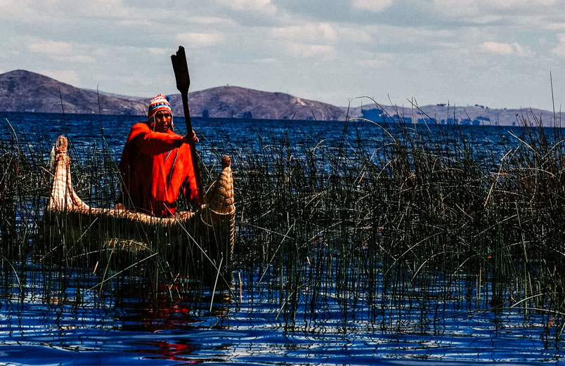 A man in a boat on a remote lake
