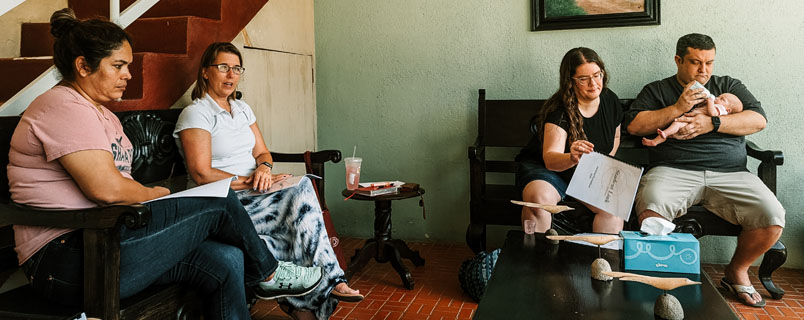 Team members and adult missionaries sitting room