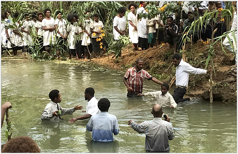 51 people being baptized in a creek