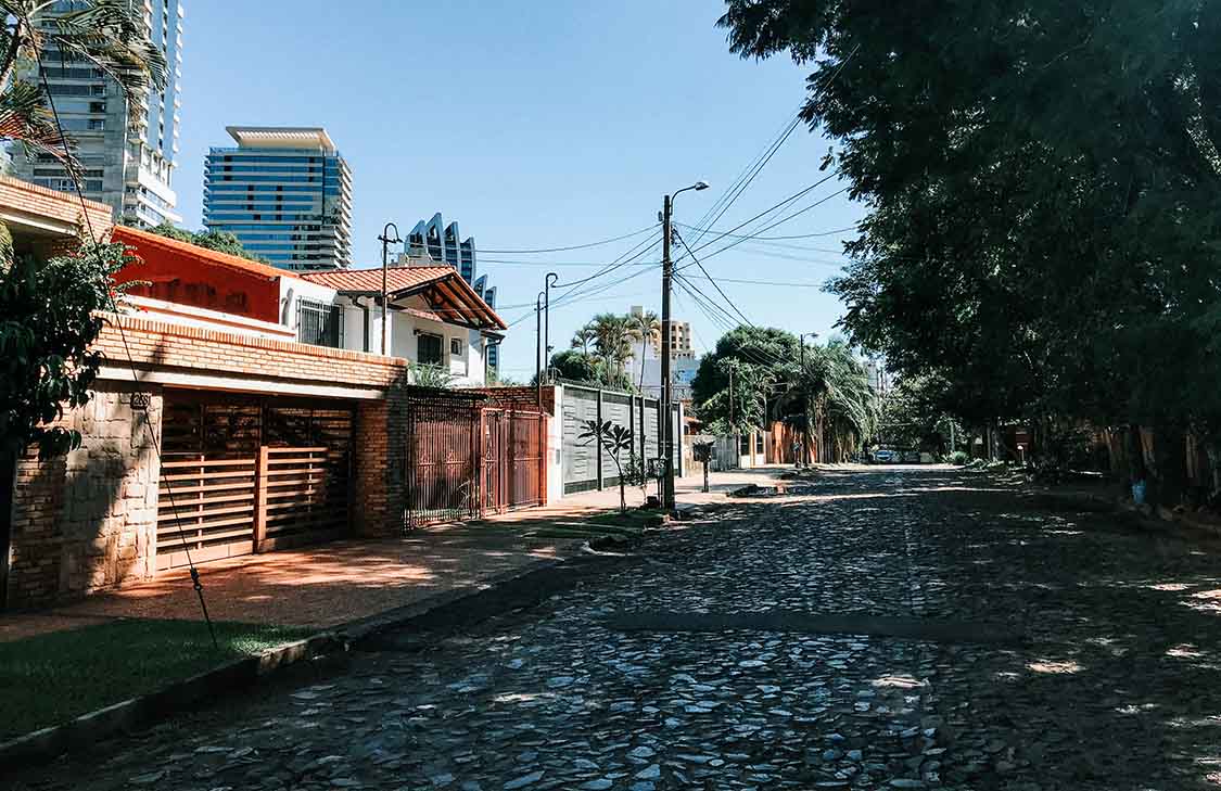 A city street in Paraguay, shaded by trees